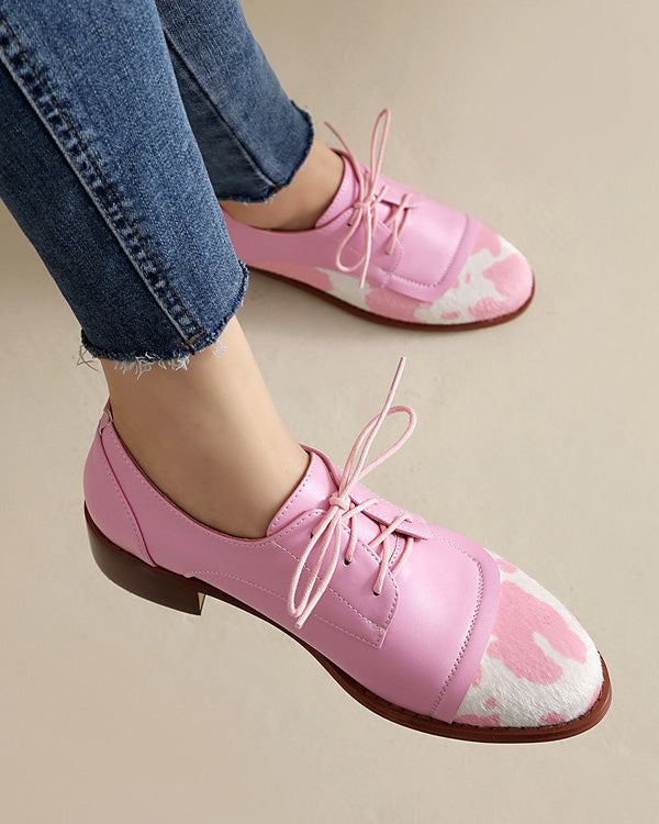 Round toe low-cut suede-trimmed cow-print loafers